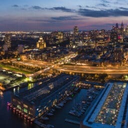 Philadelpia Downtown at sunset. The view from the Benjamin Franklin Bridge over the piers in Old City and Delaware River. Pennsylvania, USA.