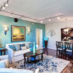 Condo interior at The Residences at Dockside. Lovely living room with blue and tan walls.