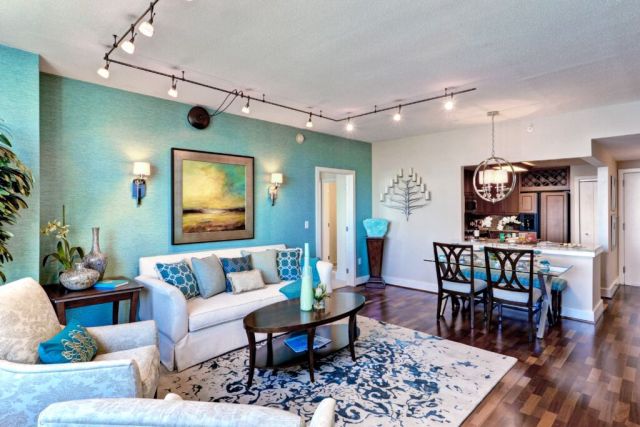 Condo interior at The Residences at Dockside. Lovely living room with blue and tan walls.