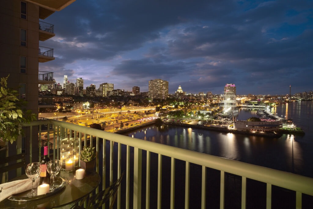 View from private terrace overlooking Penn's Landing and Philly Skyline at Night.