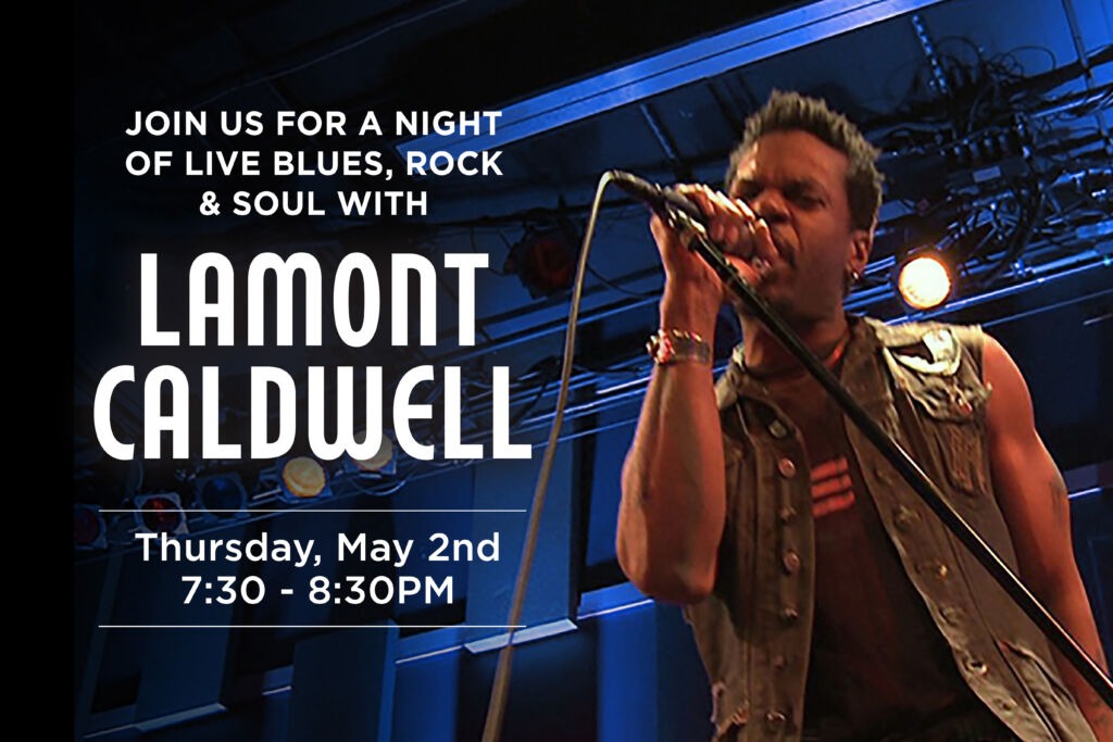 Lamont Caldwell singing on blue light stage.