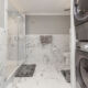 Gorgeous marbled bathroom with walk-in shower with glass doors in Philadelhia condominium available to own