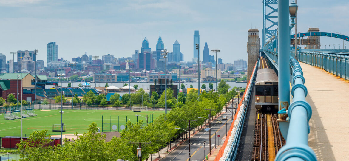 Skyline of Philadelphia, Pennsylvania, USA as seen from Camden New Jersey, featuring the Delaware River and Benjamin Franklin Bridge.