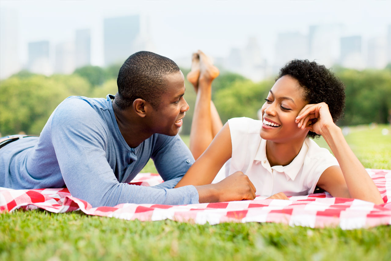 A couple picnicking by the Waterfront at Penn's Landing near Dockside Condominiums for sale