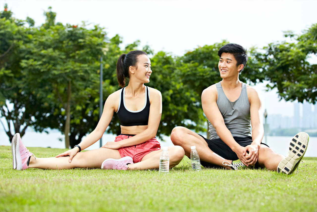 A woman and man stretching after a jog along the Waterfront at Penn’s Landing near Dockside Condominiums