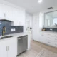 Luxury kitchen with stainless steel appliances in three bedroom condo