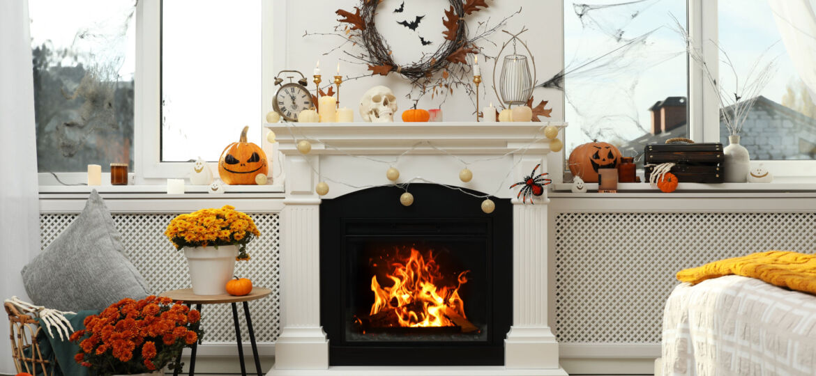 Modern room with fireplace decorated for Halloween. Festive interior